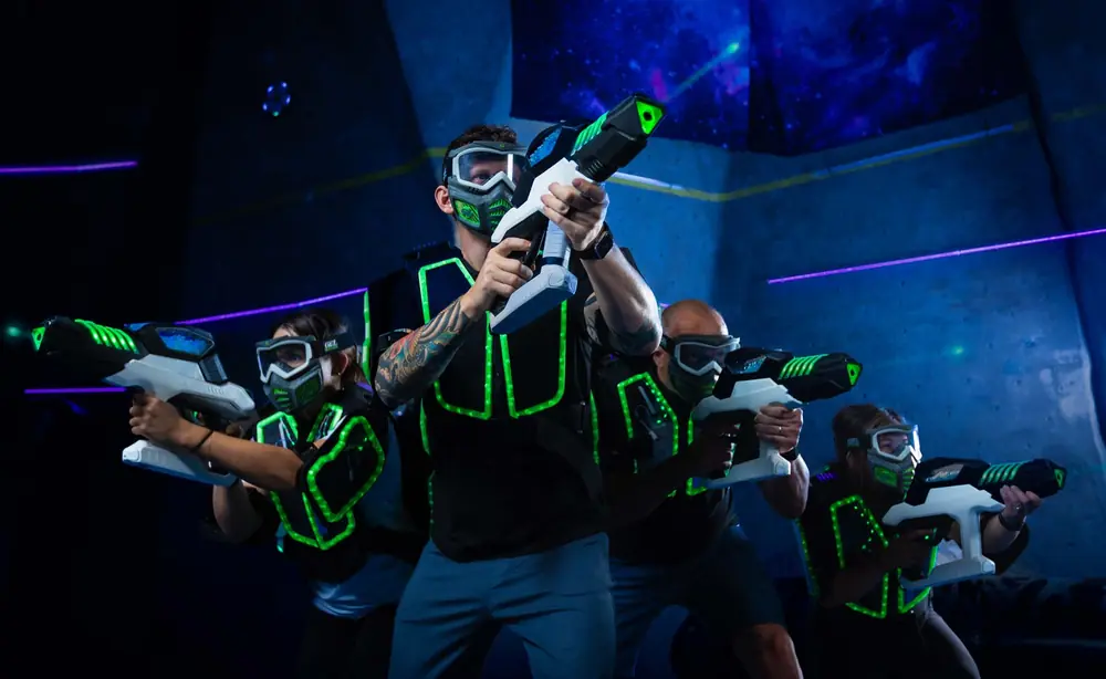 Players in glowing vests with gel blasters