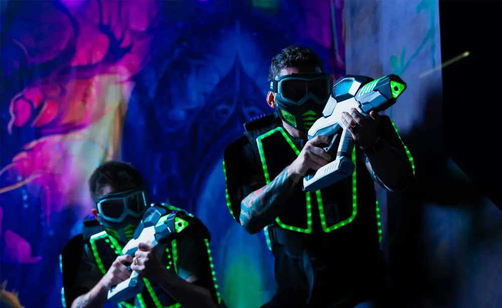 Laser tag players in glowing vests